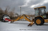 The stuck snowplow and the backhoe loader