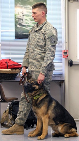 Pfc. Zachary Pilarcik a military working dog handler and patrol explosive detector dog Tomi both with the 510th Military Police Detachment (Military Working Dog), 716th Military Police Battalion, 101st Sustainment Brigade, 101st Airborne Division (Air Assault) takes part in a presentation Feb. 26, at Wassom Middle School at Fort Campbell, Ky. (Sgt. Leejay Lockhart, 101st Sustainment Brigade Public Affairs)