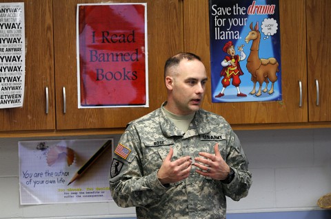 Staff Sgt. Jonathan Rose, the operations NCO of the military working dog section, 510th Military Police Detachment (Military Working Dog), 716th Military Police Battalion, 101st Sustainment Brigade, 101st Airborne Division (Air Assault), talks to students Feb. 26, at Wassom Middle School at Fort Campbell, Ky. Rose taught the students about how MPs use dogs to keep the installation safe. (Sgt. Leejay Lockhart, 101st Sustainment Brigade Public Affairs)