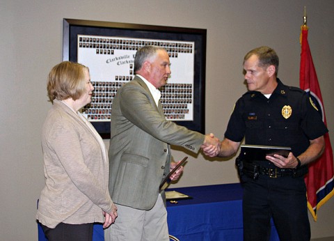 Chief Al Ainsley presents with Sgt. David Jones with his retirement certificate