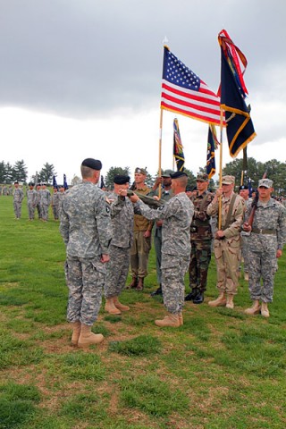 Maj. Gen. James C. McConville (left), commanding general, 101st Airborne Division (Air Assault), looks on as Col. Val C. Keaveny, Jr. (center), former commander of 4th Brigade Combat Team, 101st Abn. Div., and Command Sgt. Maj. Franklin Velez (right), command sergeant major of 4th BCT, 101st Abn. Div., case the brigade colors during the inactivation and relinquishment of command ceremony at the division parade field on Fort Campbell, KY April 25th, 2014. (U.S. Army photo by Sgt. Justin A. Moeller, 4th BCT Public Affairs)