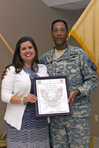 Col. Charles R. Hamilton, commander of the 101st Sustainment Brigade (Lifeliners), 101st Airborne Division (Air Assault), gives Amy Shenk the 101st Airborne Division (AA) and Fort Campbell Eagle Service Award during a volunteer appreciation ceremony, May 8, 2014, at Fort Campbell, KY. (U.S. Army photo by Sgt. Sinthia Rosario, 101st Sustainment Brigade Public Affairs)