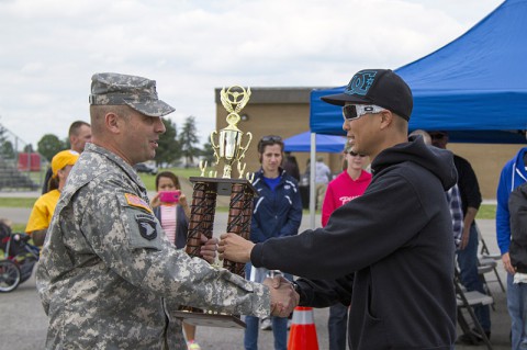 Col. Val C. Keaveny Jr., former commander, 4th Brigade Combat Team, 101st Airborne Division (Air Assault), presents the first-place prize for the import category of the 2014 Week of the Eagles Car Show to Staff Sgt. Kevin Chau, a transmissions systems operator-maintainer assigned to HHC, 3rd Brigade Combat Team, 101st Abn. Div., May 17, 2014, at Fort Campbell, KY. (U.S. Army photo by Sgt. Leejay Lockhart, 101st Sustainment Brigade Public Affairs)