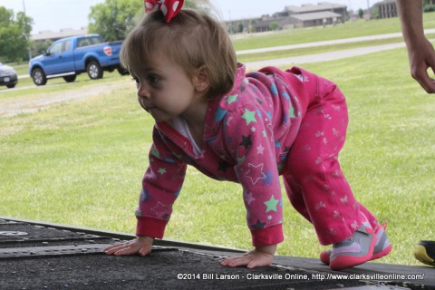 A toddler climbing up the aft ramp of a CH47 Helicopter 