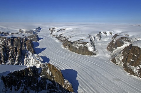 A glacier in the Sukkertoppen ice cap, southwest Greenland, flows down a rocky canyon like those mapped in this study. (NASA)