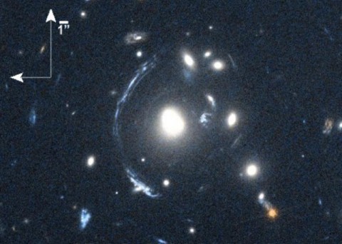 The young galaxy SDSS090122.37+181432.3, also known as S0901, is seen here as the bright arc to the left of the central bright galaxy. (NASA/STScI; S. Allam and team; and the Master Lens Database, L. A. Moustakas, K. Stewart, et al (2014))