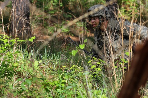 A U.S. Army Soldier with 4th Infantry Brigade Combat Team (Airborne), 25th Infantry Division moves toward a breach in a wire obstacle during a decisive action training environment exercise at the Joint Readiness Training Center in Fort Polk, LA, April 25, 2014. The decisive action training environment tests a brigade combat team's ability to conduct offensive, defensive and stability operations while supporting a foreign government. (Photo by Staff Sgt. Christopher Klutts, 20th Public Affairs Detachment)