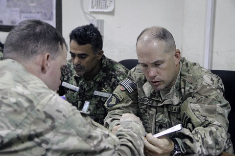 U.S. Army Lt. Col. Travis Thompson (right), the deputy commander of 2nd Brigade Combat Team, 101st Airborne Division, listens to a peer while advising his counterpart with the 201st corps Afghan National Army at Forward Operating Base Gamberi in Laghman province, June 14, 2014. (Sgt. David Cox, 2nd Brigade Combat Team Public Affairs)