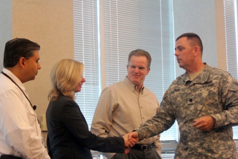 Dollar General Corporation donated backpacks to the Tennessee National Guard Child and Youth Program for their Youth Development Week in July. The camp is hosted every year for military-connected youth in the state of Tennessee. Lt.  Col. James Reed, Deputy Director for the Tennessee National Guard Military Family Readiness Operations, presents a coin to the Community Initiatives team.