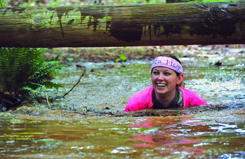 Carissa Weishuhn, wife of Spc. Jeremy Wishuhn, Fox Company, 1st Battalion, 160th Special Operations Aviation Regiment (A), trudges through a trench of mud and water during the obstacle course portion of the SOAR Challenge Tuesday afternoon. In its third year, the day-long event allows Night Stalker spouses to build morale and camaraderie by sharing the training experiences of their Soldiers. (Major Alan Hill, 160th SOAR (A) Public Affairs)