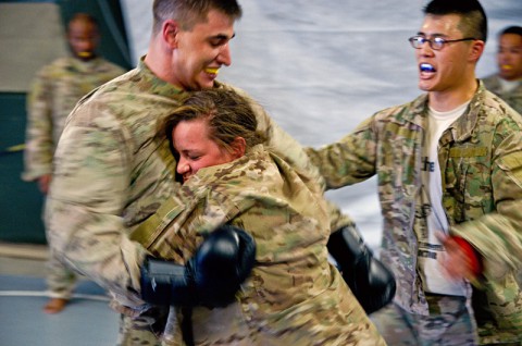 Pfc. Chelsea Kasper conducts a clench drill against Staff Sgt. Marshall Cote during level one Combatives training. Clench drills are used to train Soldiers to close the gap between them and their opponent and limit mobility. (Courtesy Photo)