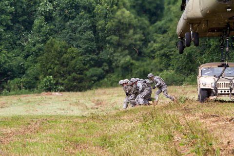 Soldiers from the 372nd Inland Cargo Transfer Company, 129th Combat Sustainment Support Battalion, 101st Sustainment Brigade, 101st Airborne Division (Air Assault), move to a safe distance after sling loading a Humvee to a CH-47 Chinook helicopter June 26, 2014, at Fort Campbell, Ky. The company held extensive rehearsals to prepare for a two-day air assault training mission. (Sgt. Leejay Lockhart, 101st Sustainment Brigade Public Affairs)