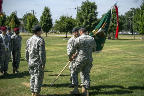 Col. John W. Brennan (right), commander of the 5th Special Forces Group (Airborne), receives the 4th Battalion colors from Lt. Col. Joseph Lock, outgoing commander of 4th Bn., 5th SFG(A), during a change of command ceremony held July 17, 2014, here at Gabriel field. (Sgt. Justin A. Moeller/U.S. Army)