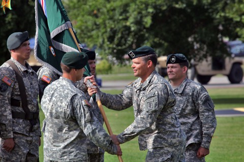 Col. John W. Brennan, commander of the 5th Special Forces Group (Airborne), passes the colors to Lt. Col. Brent W. Lindeman, the incoming commander of 3rd Battalion, 5th SFG(A), during a change of command ceremony, July 1, 2014, held at Gabriel Field. (Pfc. Robert Vanegas)