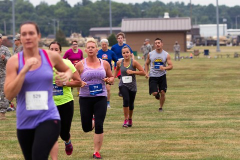 Participants in the 2014 Eagle Challenge Fitness Tour Functional Fitness Challenge sprint from the Single Arm Dumb Bell Push Press station to the next challenge July 19, at Fort Campbell. (Leejay Lockhart)