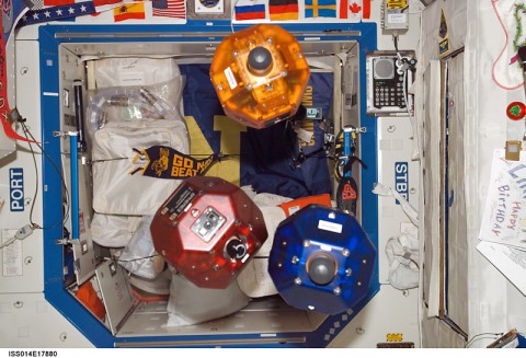 Three satellites fly in formation as part of the Synchronized Position Hold, Engage, Reorient, Experimental Satellites (SPHERES) investigation. This image was taken during Expedition 14 in the Destiny laboratory module. (NASA)