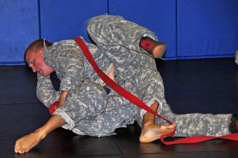 Sgt. Derek A. Youngs (right), a wheeled vehicle mechanic with 1st Platoon, Headquarters and Headquarters Company, 160th Special Operations Aviation Regiment (Airborne) transitions from side control to full mount during a combatives tournament June 25, 2014. (Sgt. 1st Class Thaddius S. Dawkins II)