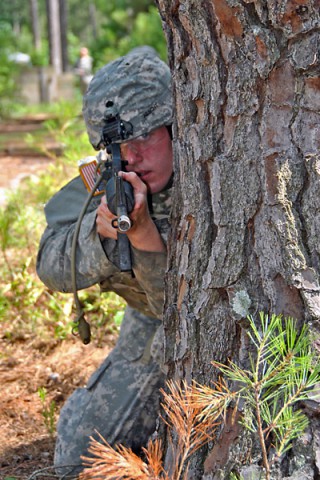 Spc. Mark E. Aescht (center), a Black Hawk crew chief with the Aviation Life Saving Equipment section, 1st Platoon, Headquarters and Headquarters Company, 160th Special Operations Aviation Regiment (Airborne) provides overwatch while reacting to contact during an Army Warrior Task lane. (Sgt. 1st Class Thaddius S. Dawkins II)