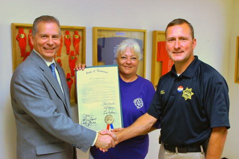 Tennessee Representative Joe Pitts presents a House Joint Resolution recognizing the Silent Witness Project to Montgomery County Sheriff's Deputy Peggy Macias and Sheriff John Fuson.