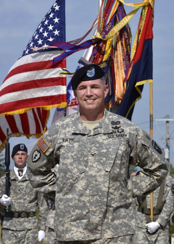 Colonel Frank W. Tate, the new deputy commanding general for support for the 101st Airborne Division (Air Assault) and Fort Campbell, smiles as he listens to Maj. Gen. Gary J. Volesky (not pictured), the commanding general of the 101st, officially welcome him to the division during his remarks at an Honor Eagle ceremony Aug. 8, 2014, in front of the division headquarters building. (U.S. Army Photo by Sam Shore)