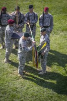 Lt. Col. John R. Dyke III, the outgoing commander of 2nd Battalion, 5th Special Forces Group (Airborne), attaches a Valorous Unit Award to the 2nd Bn. colors, July 31, 2014, during the 2nd Bn. Change of Command ceremony. (Sgt. Justin A. Moeller/U.S. Army)