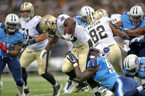 New Orleans Saints running back Khiry Robinson (29) is tackled by Tennessee Titans defensive end Kamerion Wimbley (95) as he carries the ball in the first half at Mercedes-Benz Superdome. (Crystal LoGiudice-USA TODAY Sports)