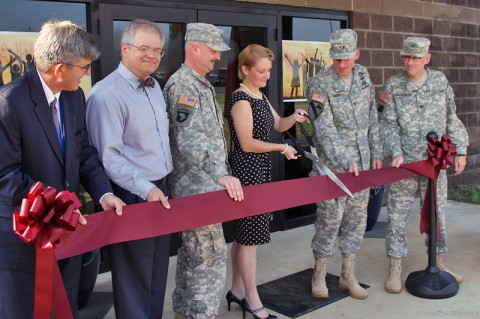 Maj. Gen. Gary J. Volesky, commanding general for the 101st Airborne Division (Air Assault) and Fort Campbell applauds and thanks Fort Campbell community member and supporter of the Child and Family Behavioral Health System Melissa Fast for cutting the ribbon, formally opening the CAFBHS service to the community. Fort Campbell Schools Superintendent Gary Gerstner, CAFBHS Director Dr. Quentin Humberd, 101st Division Band member Staff Sgt. Aaron Fast and BACH commander Col. George N. Appenzeller held the ribbon as Melissa Fast cut the ribbon Aug. 27. (Fred Holly)