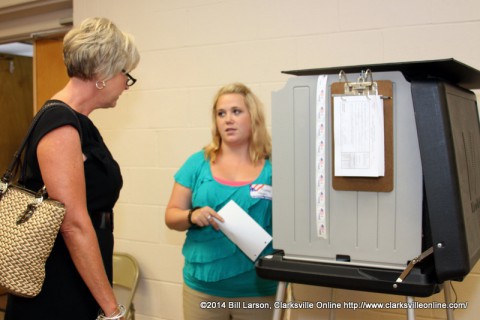 A poll worker explains the process to Melinda Shepard before she casts her ballot