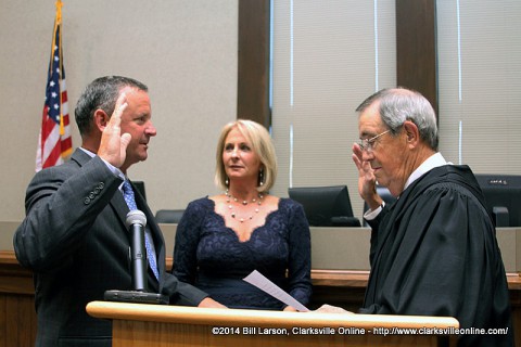 Montgomery County Mayor Jim Durrett being sworn in by Judge John Peay (Ret.) as his wife Mary looks on