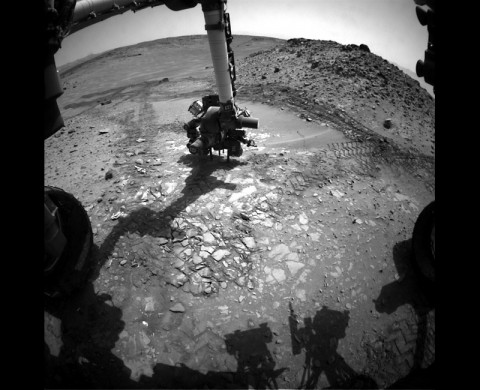 This image from the front Hazcam on NASA's Curiosity Mars rover shows the rover's drill in place during a test of whether the rock beneath it, "Bonanza King," would be an acceptable target for drilling to collect a sample. Subsequent analysis showed the rock budged during the Aug. 19, 2014, test. (NASA/JPL-Caltech)