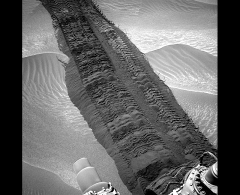 This image from the Navigation Camera on NASA's Curiosity Mars rover shows wheel tracks printed by the rover as it drove on the sandy floor of a lowland called "Hidden Valley" on the route toward Mount Sharp. The image was taken on Aug. 4, 2014. 