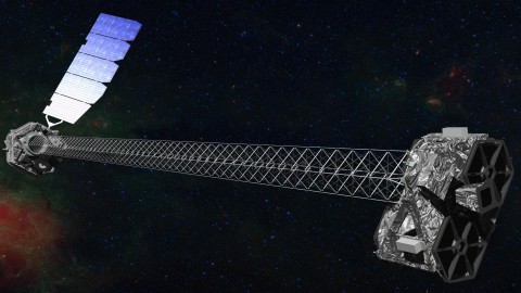 Artist's concept of NuSTAR on orbit. NuSTAR has a 10-m (30') mast that deploys after launch to separate the optics modules (right) from the detectors in the focal plane (left). The spacecraft, which controls NuSTAR's pointings, and the solar panels are with the focal plane. NuSTAR has two identical optics modules in order to increase sensitivity. The background is an image of the Galactic center obtained with the Chandra X-ray Observatory. 