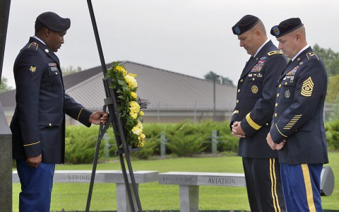 Brigadier General Mark R. Stammer (center), the deputy commanding general for operations for the 101st Airborne Division (Air Assault), and Command Sgt. Maj. Gabriel A. Espinosa Jr. (right), the Fort Campbell garrison command sergeant major, observe a moment of silence after laying a wreath Sept. 11, 2014, to honor those who lost their lives in the Sept. 11, 2001, terrorist attacks. The division's honor guard would later fire a 21-gun salute and play Taps during the solemn ceremony. (Sam Shore)