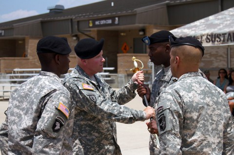 Command Sgt. Maj. Dennis Collins, the outgoing senior enlisted adviser for the 129th Combat Sustainment Support Battalion, 101st Sustainment Brigade, 101st Airborne Division (Air Assault), passes the NCO sword to Lt. Col. Abel Young, commander of the 129th CSSB, during a change of responsibility ceremony July 11, at Fort Campbell, Ky. The 129th CSSB transported over 6,000 containers and 10,000 Air Assault Soldiers on 300 division missions during Collins tenure. (U.S. Army photo by Sgt. Leejay Lockhart)