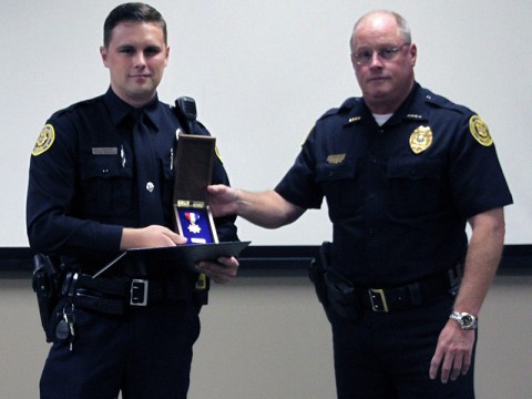 Officer Brett Wiessing (left) and Deputy Chief Mike Parr (right), receiving the Lifesaving Medal.