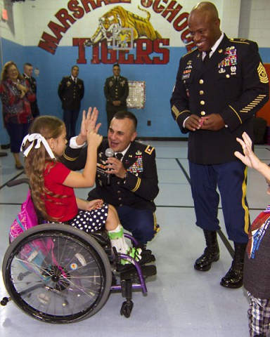 Lt. Col. Alexander Gallegos (right), commander of 101st Special Troops Battalion “Sustainers,” 101st Sustainment Brigade “Lifeliners,” 101st Airborne Division, along with Command Sgt. Maj. Christopher Crawford, senior enlisted adviser, 101st STB, talk to students at Marshall Elementary School during an assembly Sept. 11. Soldiers also read stories to students and discussed the importance of 9/11 in American history. (U.S. Army photo by Sgt. Leejay Lockhart, 101st Sustainment Brigade Public Affairs)