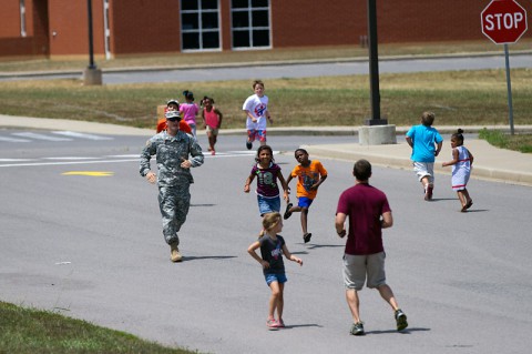 Pvt. Adam Grine, a native of Fostoria, Ohio, and a volunteer from Headquarters and Headquarters Detachment, 716th Military Police Battalion, 101st Sustainment Brigade, 101st Airborne Division, participates in a fun run with students during a back-to-school bash Saturday, at West Creek Elementary School in Clarksville, Tenn. Soldiers have volunteered at the school since it opened seven years ago. (Sgt. Leejay Lockhart, 101st Sustainment Brigade Public Affairs) Pvt. Adam Grine, a native of Fostoria, Ohio, and a volunteer from Headquarters and Headquarters Detachment, 716th Military Police Battalion, 101st Sustainment Brigade, 101st Airborne Division, participates in a fun run with students during a back-to-school bash Saturday, at West Creek Elementary School in Clarksville, Tenn. Soldiers have volunteered at the school since it opened seven years ago. (Sgt. Leejay Lockhart, 101st Sustainment Brigade Public Affairs)