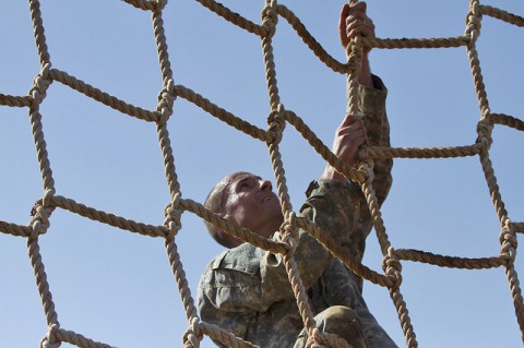 Command Sgt. Maj. David J. Tookmanian, a native of Hillsdale, N. J., and command sergeant major of the 716th Military Police Battalion “Peacekeepers,” 101st Sustainment Brigade, 101st Airborne Division (Air Assault), climbs a cargo rope at the Special Forces obstacle course during the Peacekeeper Challenge competition, Aug. 21, 2014, at Fort Campbell, Ky.  (U.S. Army photo by Sgt. Sinthia Rosario)