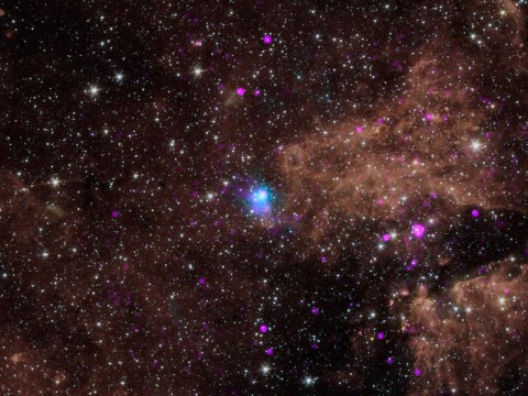 The blue dot in this image marks the spot of an energetic pulsar -- the magnetic, spinning core of star that blew up in a supernova explosion. (NASA/JPL-Caltech/SAO)