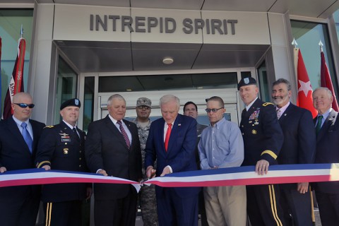 Staff Sgt. Todd Domorese, Maj. Gen. Richard W. Thomas, retired Gen. Richard Cody, Spc. Miguel Hernandez, Arnold Fisher, Dave Winters, Sgt. Maj. Robert Haemmerle, Maj. Gen. Gary J. Volesky, Dr. Brett Logan, and retired Lt. Gen. Edgar Anderson help cut the ribbon at the Intrepid Fallen Heroes Fund dedication of the new Intrepid Spirit Center, on Monday, Sept. 8, 2014 at Fort Campbell, KY. (Dean Dixon/AP Images for AP Images for Intrepid Fallen Heroes)