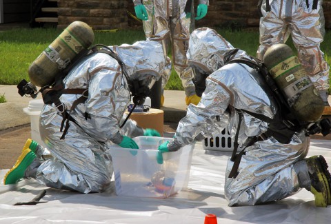 Agents with the 19th Judicial District Drug Task Force get ready to enter a meth lab in a Madison Street hotel with the help of Clarksville Fire Rescue and Montgomery County EMS.