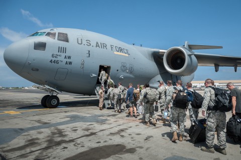 A group of 30 U.S. military personnel, including Marines, Airmen, and Soldiers from the 101st Airborne Division, board a U.S. Air Force C-17 Globemaster III at Léopold Sédar Senghor International Airport in Dakar, Senegal, Oct. 19, 2014. The service members are bound for Monrovia, Liberia, where U.S. troops will construct medical treatment units and train health care workers as part of Operation United Assistance, the U.S. Agency for International Development-led, whole-of-government effort to respond to the Ebola outbreak in West Africa. (Maj. Dale Greer/U.S. Air National Guard)