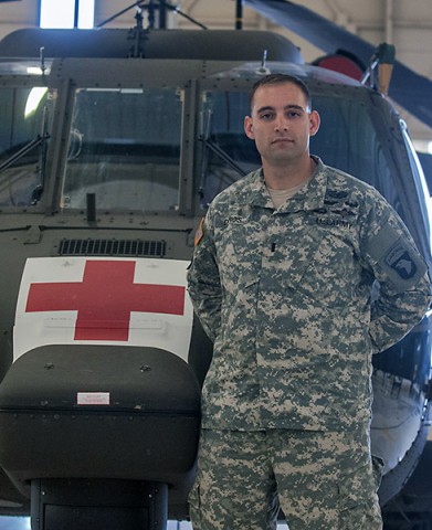 First Lt. Kenneth Danos, aeromedical-evacuation pilot, Company C, 6th Battalion, 101st Combat Aviation Brigade, 101st Airborne Division (Air Assault), poses in front of an HH-60M medevac Black Hawk Helicopter, here, Oct. 15, 2014. Danos was the honor graduate for receiving zero no-gos during his testing phase at the 2014 expert field medical badge lanes. (Sgt. Duncan Brennan, 101st CAB Public Affairs)