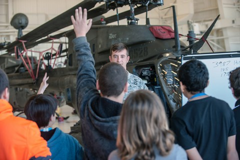 Chief Warrant Officer 2 Frank Laudano, OH-58D Kiowa Warrior helicopter pilot, Headquarters and Headquarters Troop, 2nd Squadron, 17th Cavalry Regiment, 101st Combat Aviation Brigade, 101st Airborne Division (Air Assault), responds to raised hands from visiting students, here, Oct. 8, 2014. The field trip by Kenwood Middle School sixth-graders was part of a broader field trip to make mathematics meaningful outside of the classroom. (Sgt. Duncan Brennan, 101st CAB Public Affairs)