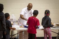 U.S. Army Sgt. 1st Class Christopher Roberts, food service sergeant with 3rd Battalion, 5th Special Forces Group (Airborne), serves food to children at the Boys and Girls Club of America in Christian County, Ky., Oct. 21, 2014, where he volunteers. (Sgt. Justin A. Moeller/U.S. Army)