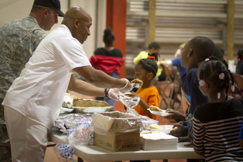 U.S. Army Sgt. 1st Class Christopher Roberts, food service sergeant with 3rd Battalion, 5th Special Forces Group (Airborne), serves food to children at the Boys and Girls Club of America in Christian County, Ky., Oct. 21, 2014, where he volunteers. (Sgt. Justin A. Moeller/U.S. Army)