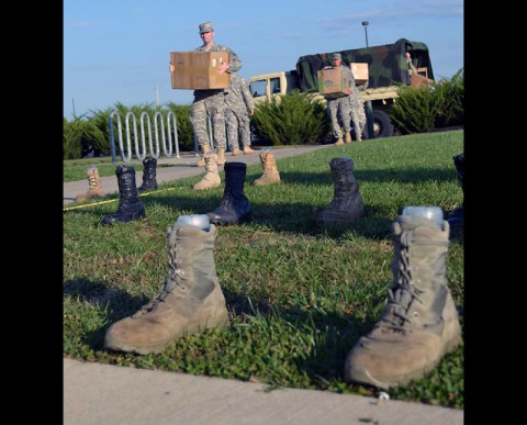 Soldiers with the 551st Military Police Company and 1/506 Infantry Regiment, 1st Brigade Combat Team setting up the Survivor Outreach Services boot display last year honoring service members who died in support of the Global War on Terror since Sept. 11, 2001. (Photo by Nondice Thurman, Fort Campbell Public Affairs Office)