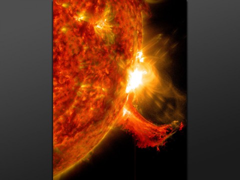 NASA's Solar Dynamics Observatory captured this image of a solar flare on Oct. 2nd, 2014. The solar flare is the bright flash of light on the right limb of the sun. A burst of solar material erupting out into space can be seen just below it. (NASA/SDO)