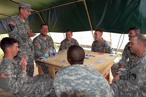 Soldiers with the 36th Engineer Brigade, Fort Hood, Texas, assigned to Joint Forces Command – United Assistance, pause their card game to talk with Maj. Gen. Gary Volesky, the commander of JFC-UA, at the National Police Training Academy, Monrovia, Liberia, Nov. 27, 2014. (Sgt. Ange Desinor, 13th Public Affairs Detachment)