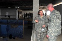 Col. Laura Favand, the chief of training, DoD Ebola Training Program, Joint Forces Command – United Assistance, explains to Maj. Gen. Gary Volesky, the JFC-UA commander, what the Ebola treatment unit volunteers encounter during their medical training. (Sgt. 1st Class Nathan Hoskins/U.S. Army)